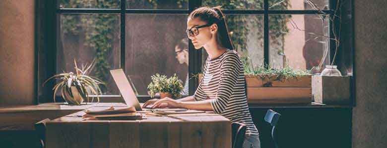 Een vrouw werkt op haar laptop met Azure Well-Architected Framework