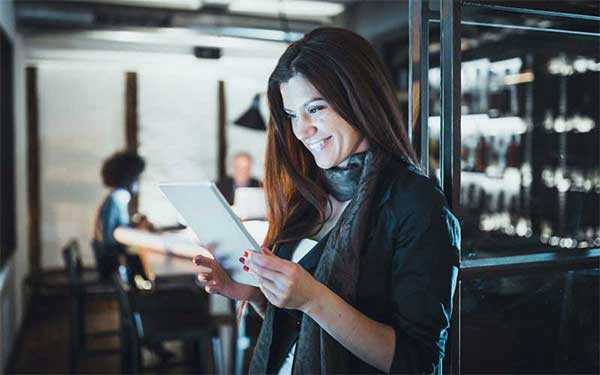 Een vrouw houdt een tablet vast