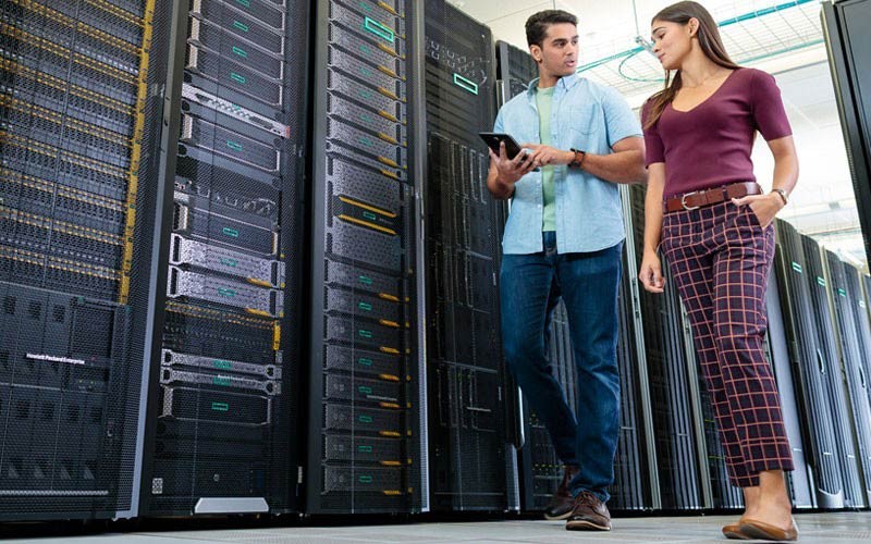 Twee medewerkers lopen door de serverruimte